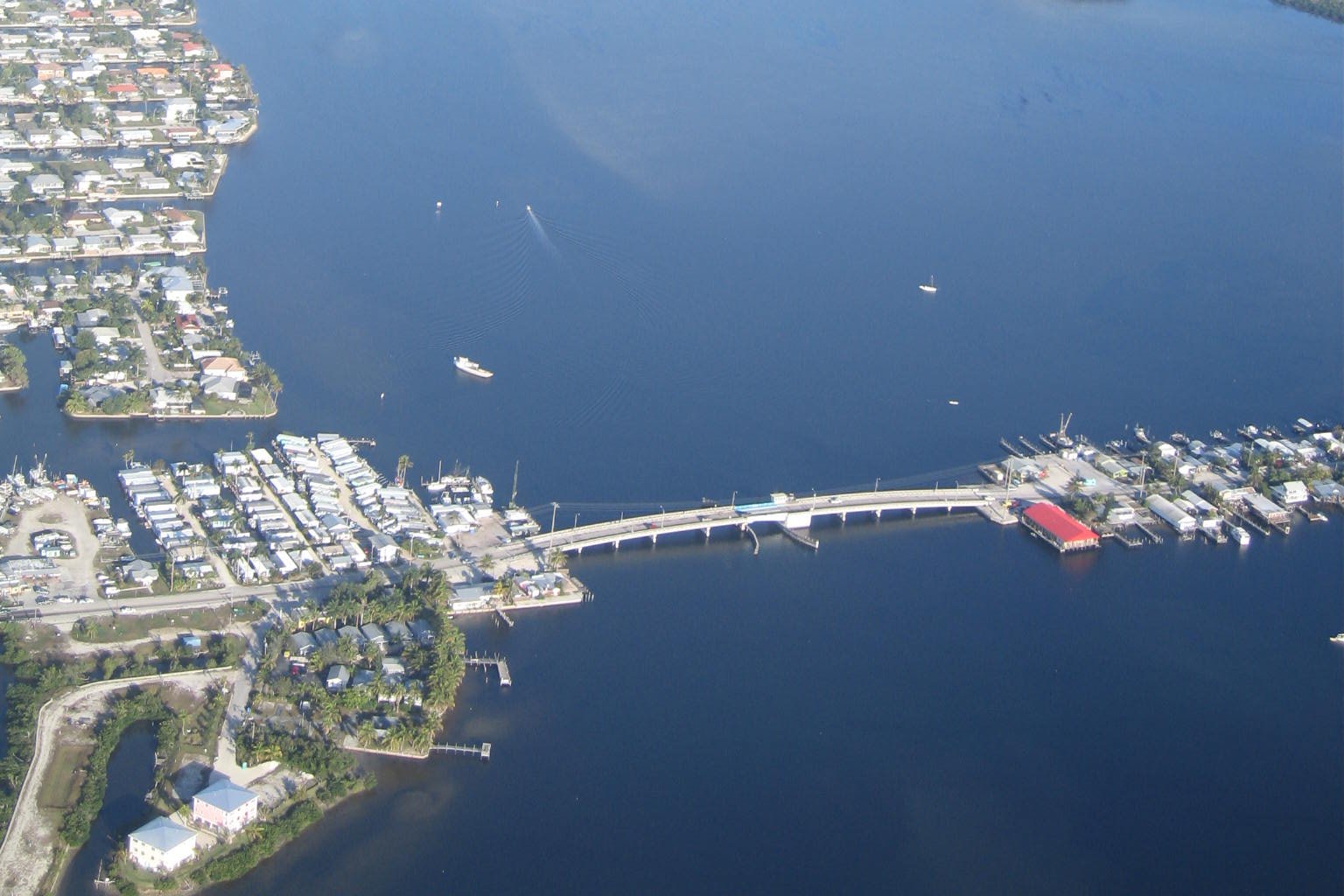 Aerial view of the old Matlacha drawbridge on Pine Island Road crossing Matlacha Pass beside the village's waterfront buildings